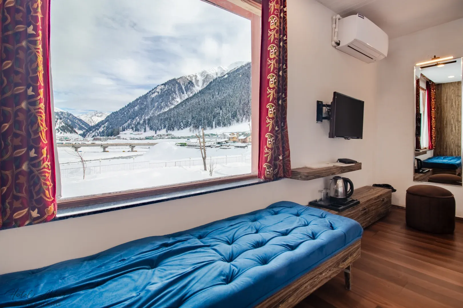 Snowy mountain panorama through hotel window.